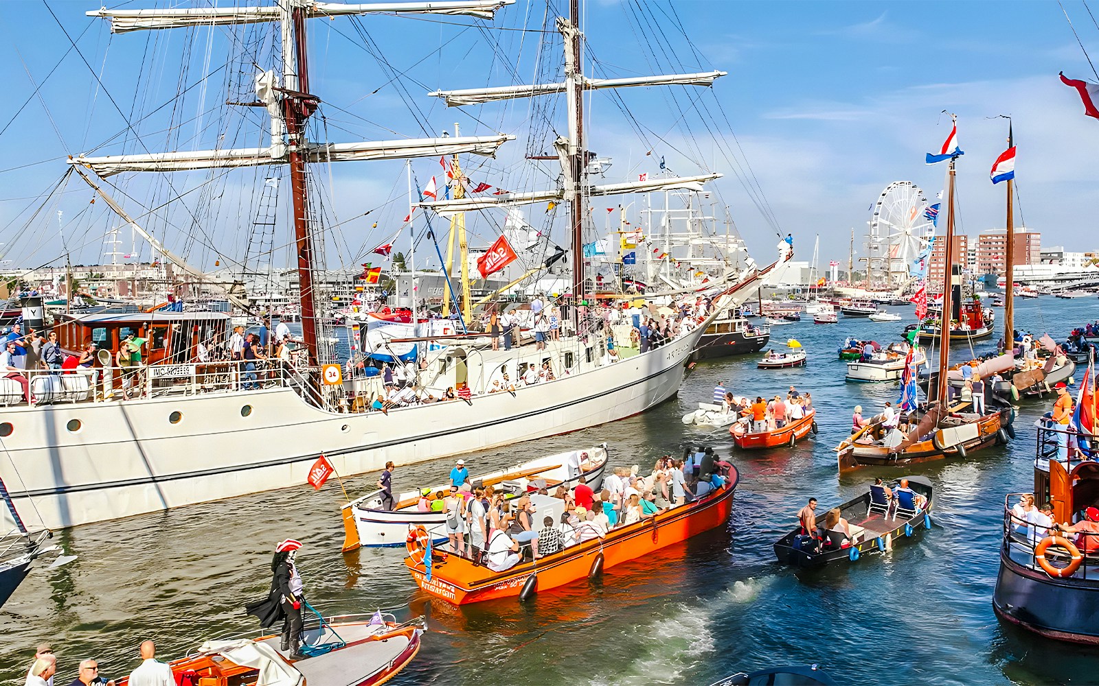 Tall ships sailing in Amsterdam harbor during SAIL Amsterdam event.
