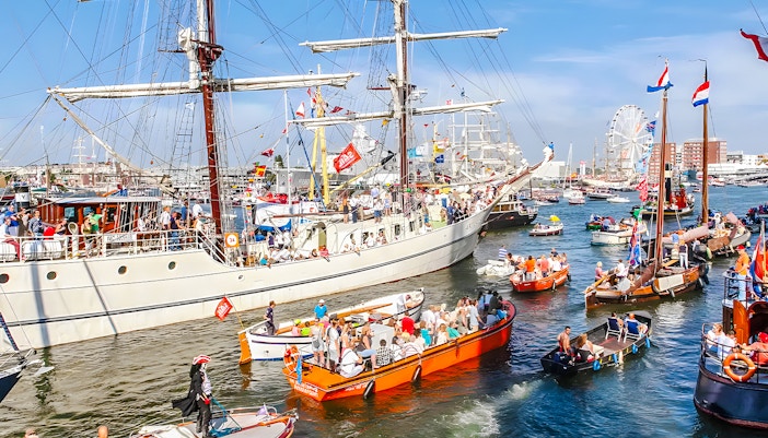 Tall ships sailing in Amsterdam harbor during SAIL Amsterdam event.