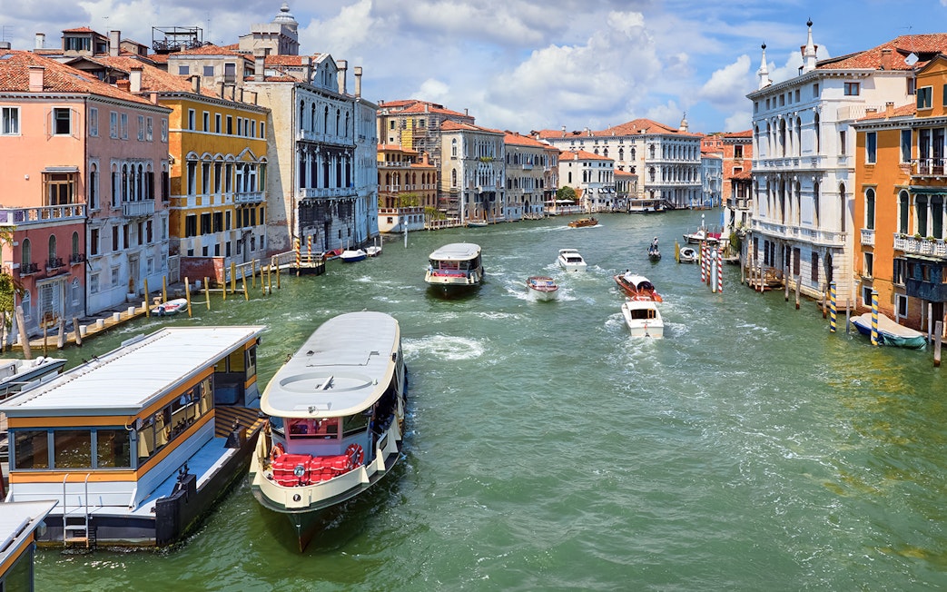 Vaporetto on Grand Canal in Venice, Italy with historic buildings in view.
