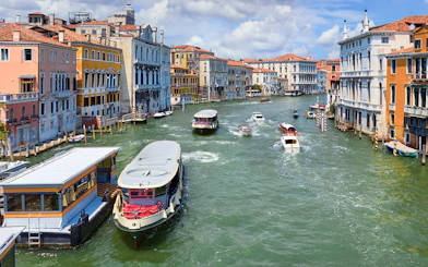 Vaporetto on Grand Canal in Venice, Italy with historic buildings in view.