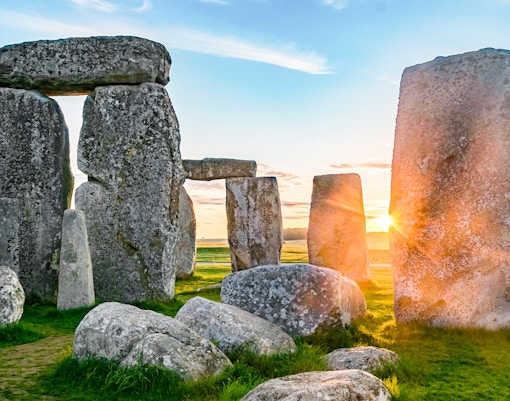 Stonehenge stones at sunrise during a full-day tour from London.