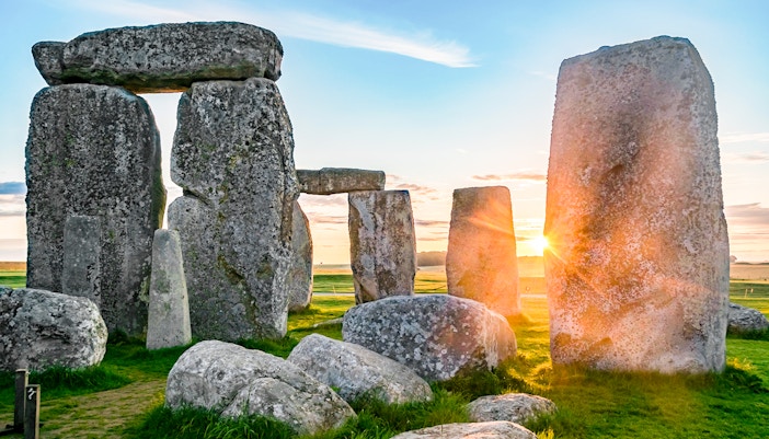 Stonehenge stones at sunrise during a full-day tour from London.