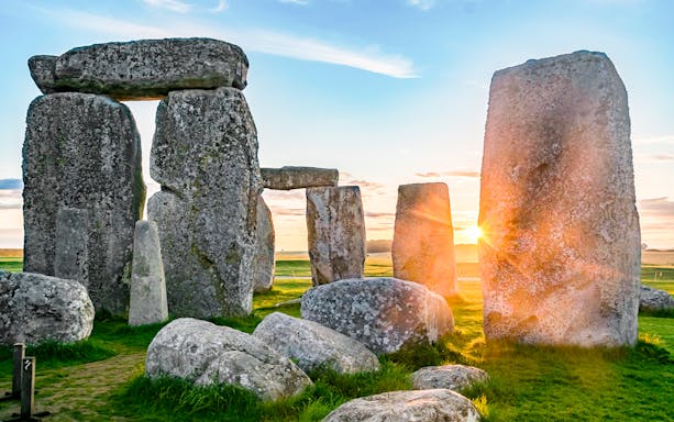 Stonehenge stones at sunrise during a full-day tour from London.