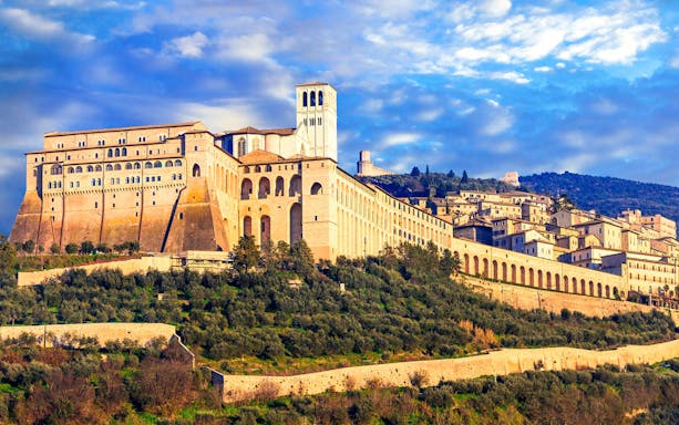 Basilica of Saint Francis in Assisi, Italy, viewed from a hillside.