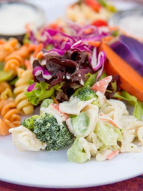 Plate of mixed salads and pasta at Paradise Cove Luau, Hawaii.