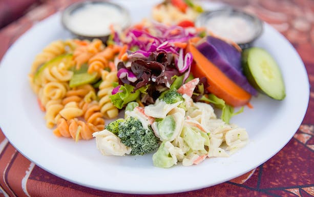 Plate of mixed salads and pasta at Paradise Cove Luau, Hawaii.