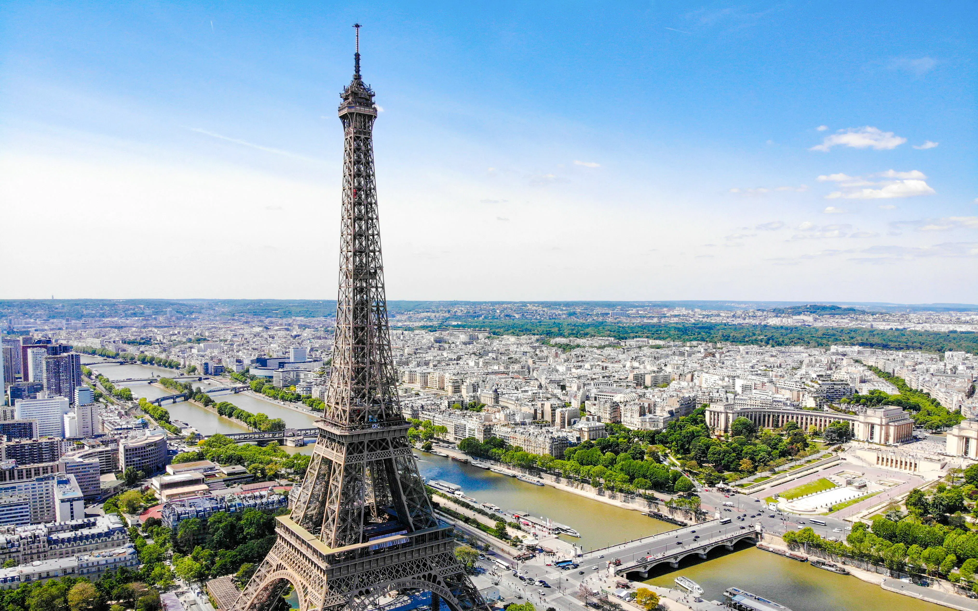 Eiffel Tower aerial view over Paris, France, with Seine River and cityscape.