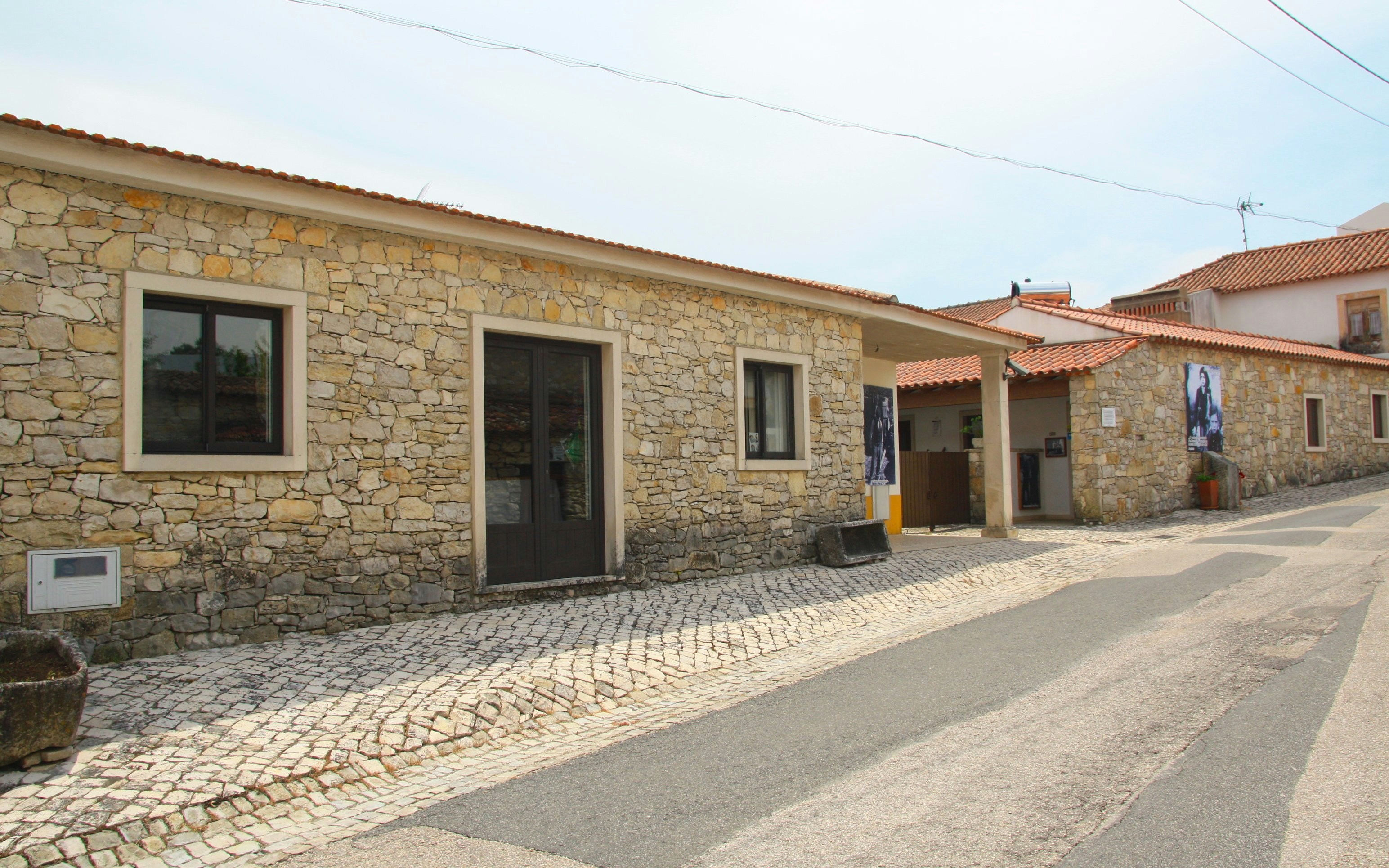 Stone building on a cobblestone street in Aljustrel near Fatima, Portugal.