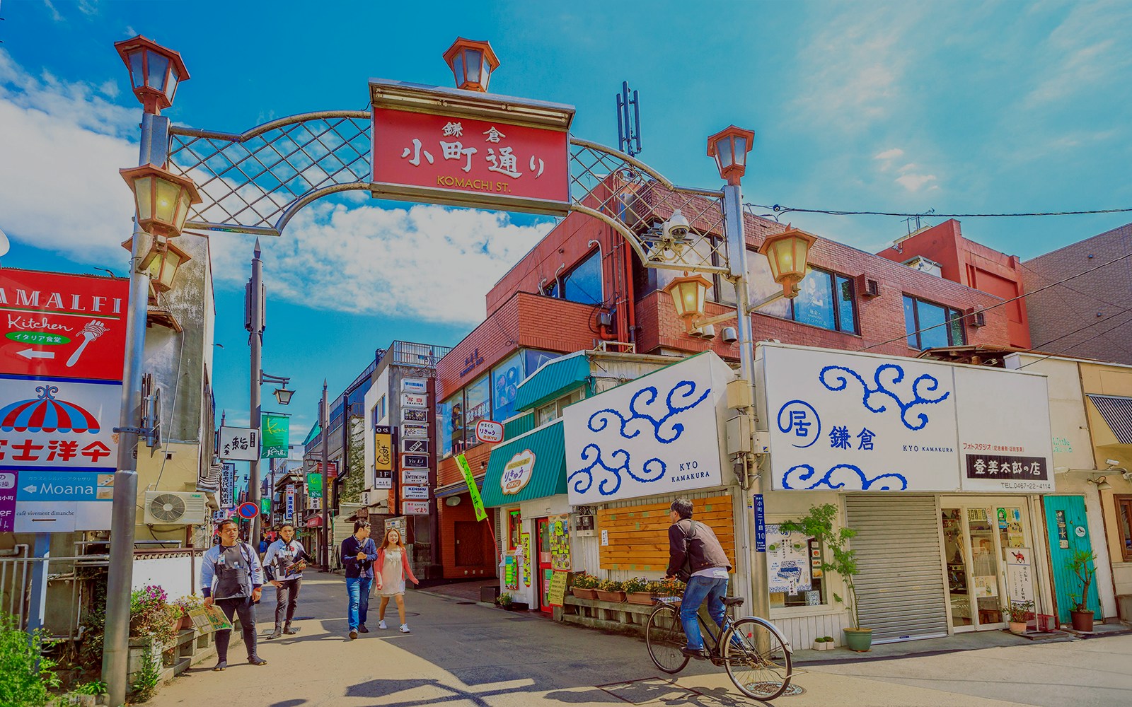 People walking along Komachi Street in Kamakura, Japan, with traditional shops and vibrant atmosphere.