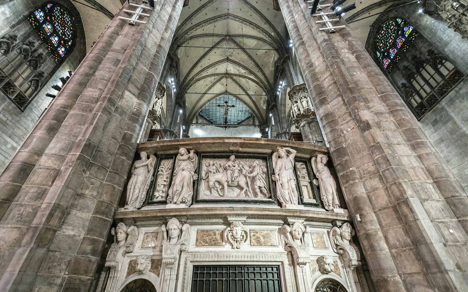 Duomo Milan Cathedral interior with ornate sculptures and vaulted ceiling.
