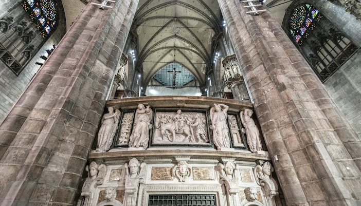 Duomo Milan Cathedral interior with ornate sculptures and vaulted ceiling.