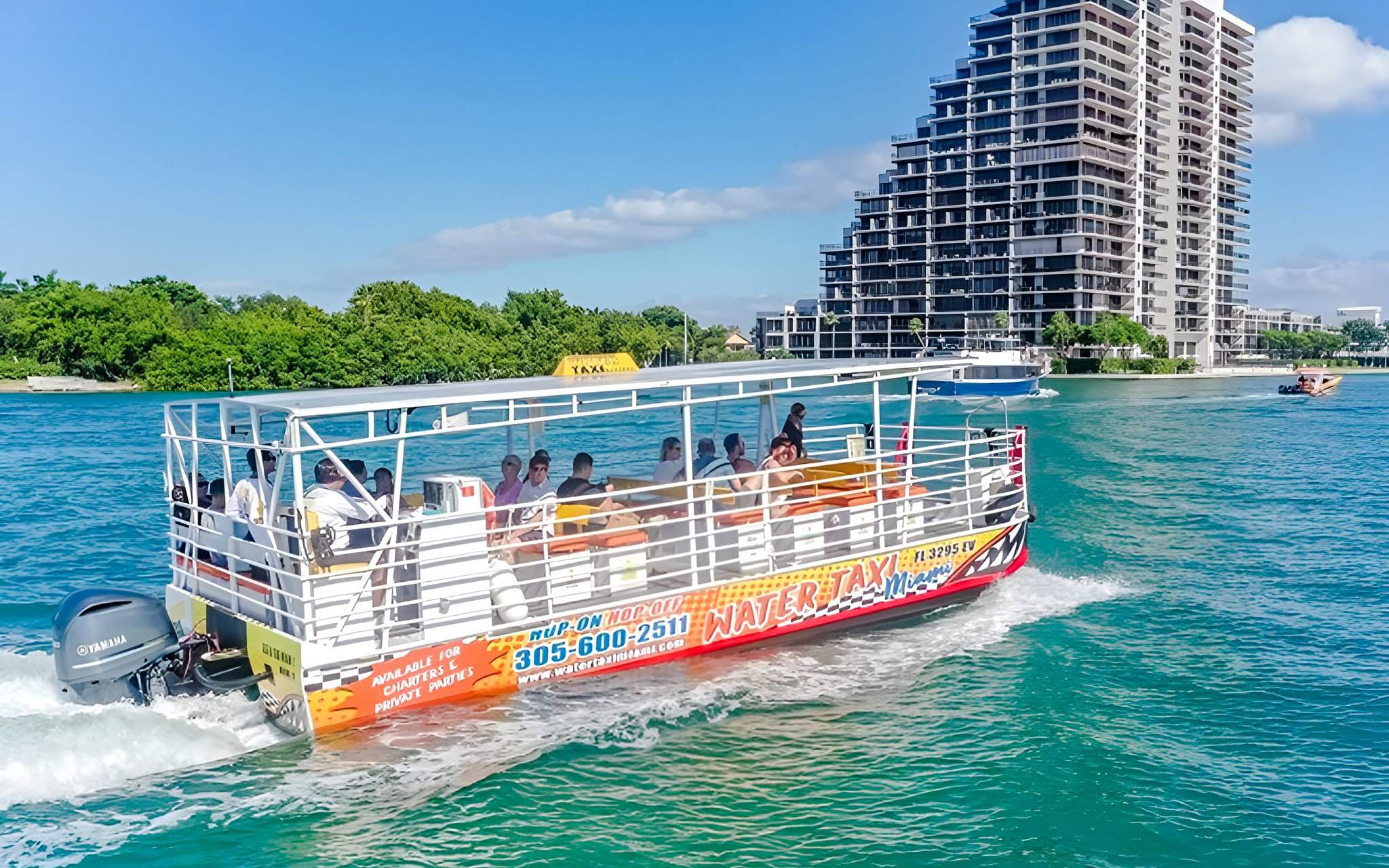 Water taxi cruising near high-rise buildings in Miami.