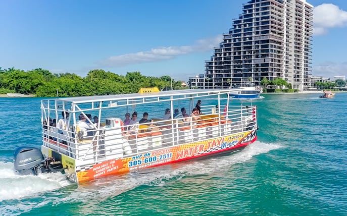 Water taxi cruising near high-rise buildings in Miami.