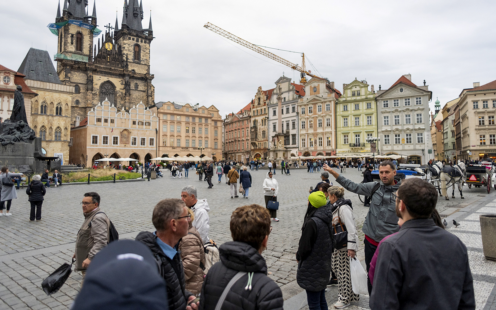 Tour group with guide in Prague's Old Town Square near Tyn Church.