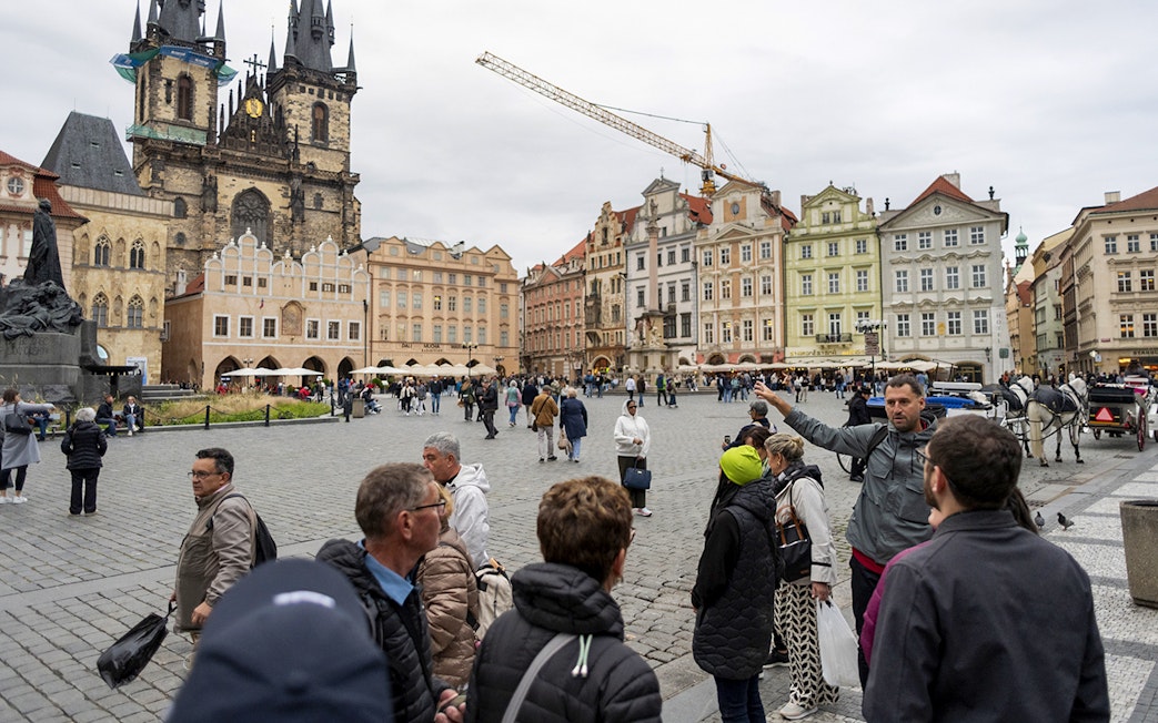 Tour group with guide in Prague's Old Town Square near Tyn Church.