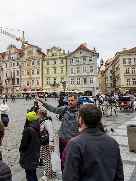 Tour group with guide in Prague's Old Town Square near Tyn Church.