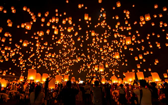 Lanterns released into night sky at Lanna Sky Lantern Festival, Thailand.