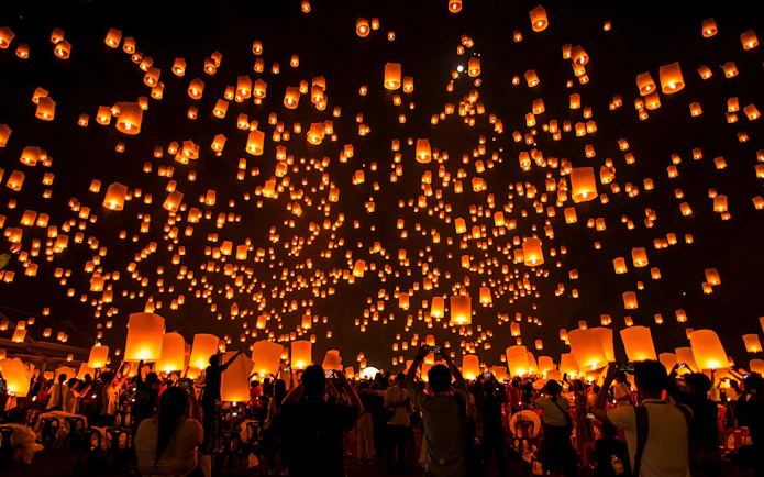 Lanterns released into night sky at Lanna Sky Lantern Festival, Thailand.