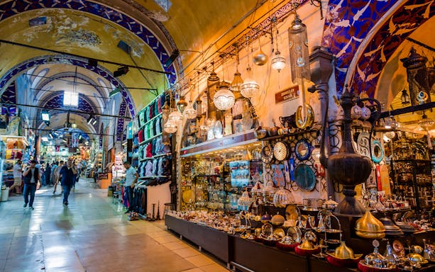 Grand Bazaar in Istanbul with colorful shops and traditional lamps on display.