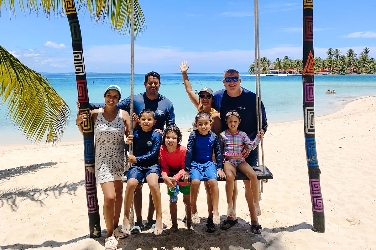 Group enjoying a beach swing on Islas de San Blas tour, Panama City.