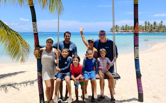 Group enjoying a beach swing on Islas de San Blas tour, Panama City.