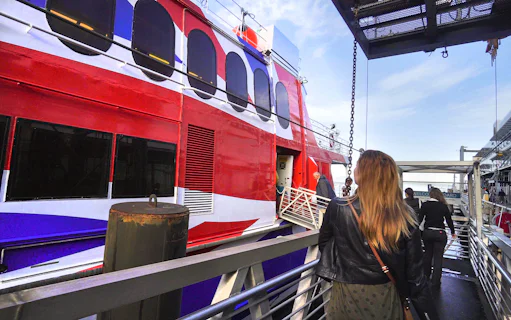 Passengers boarding high-speed ferry from Seattle to Victoria with Puget Sound views.