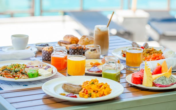 Breakfast spread with fruits, pastries, and juices at Sea Angel pier.