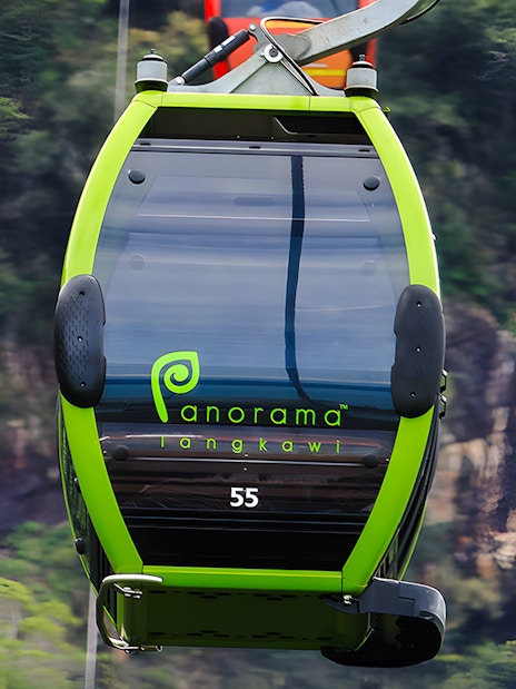 Private gondola on Langkawi cable car with forested hills in the background.
