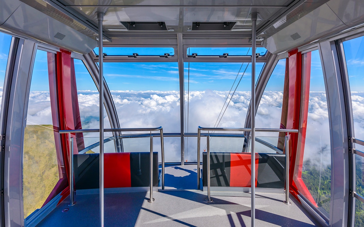 Cable car interior with panoramic view of clouds on route to Pilatus Kulm from Kriens.