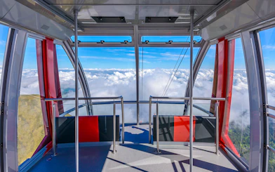 Cable car interior with panoramic view of clouds on route to Pilatus Kulm from Kriens.
