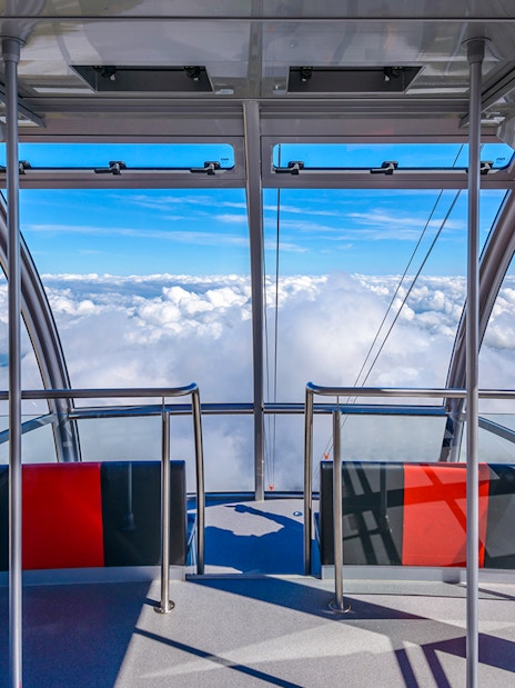 Cable car interior with panoramic view of clouds on route to Pilatus Kulm from Kriens.