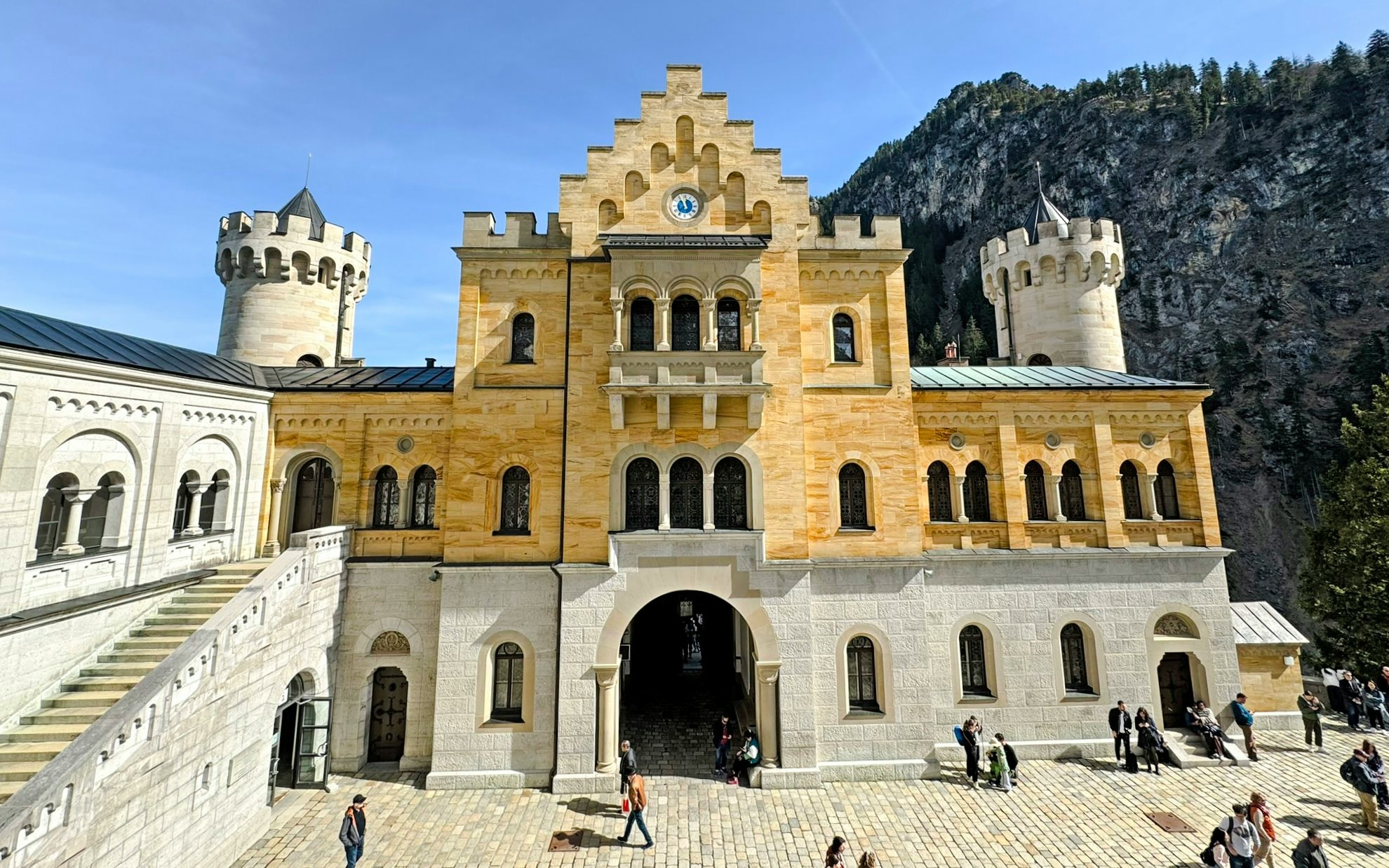 Courtyard view of Neuschwanstein Castle's interior with stone facade and towers.