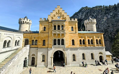 Courtyard view of Neuschwanstein Castle's interior with stone facade and towers.