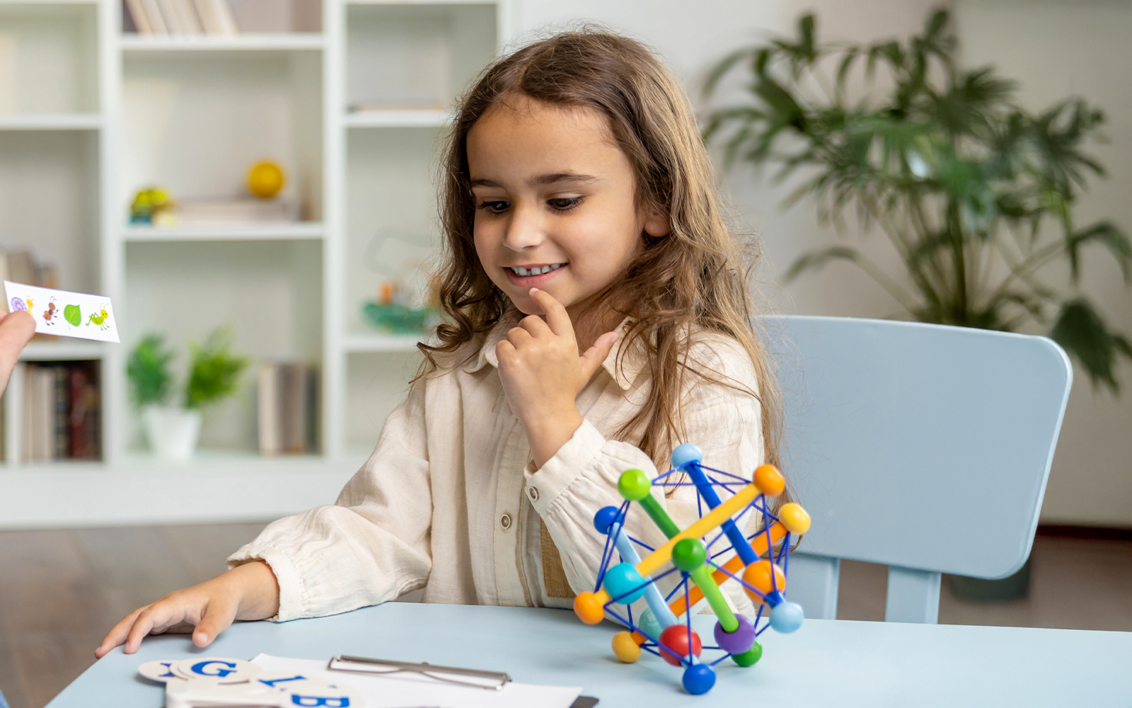 Neurodivergent girl engaging with interactive toys in a sensory-friendly room.
