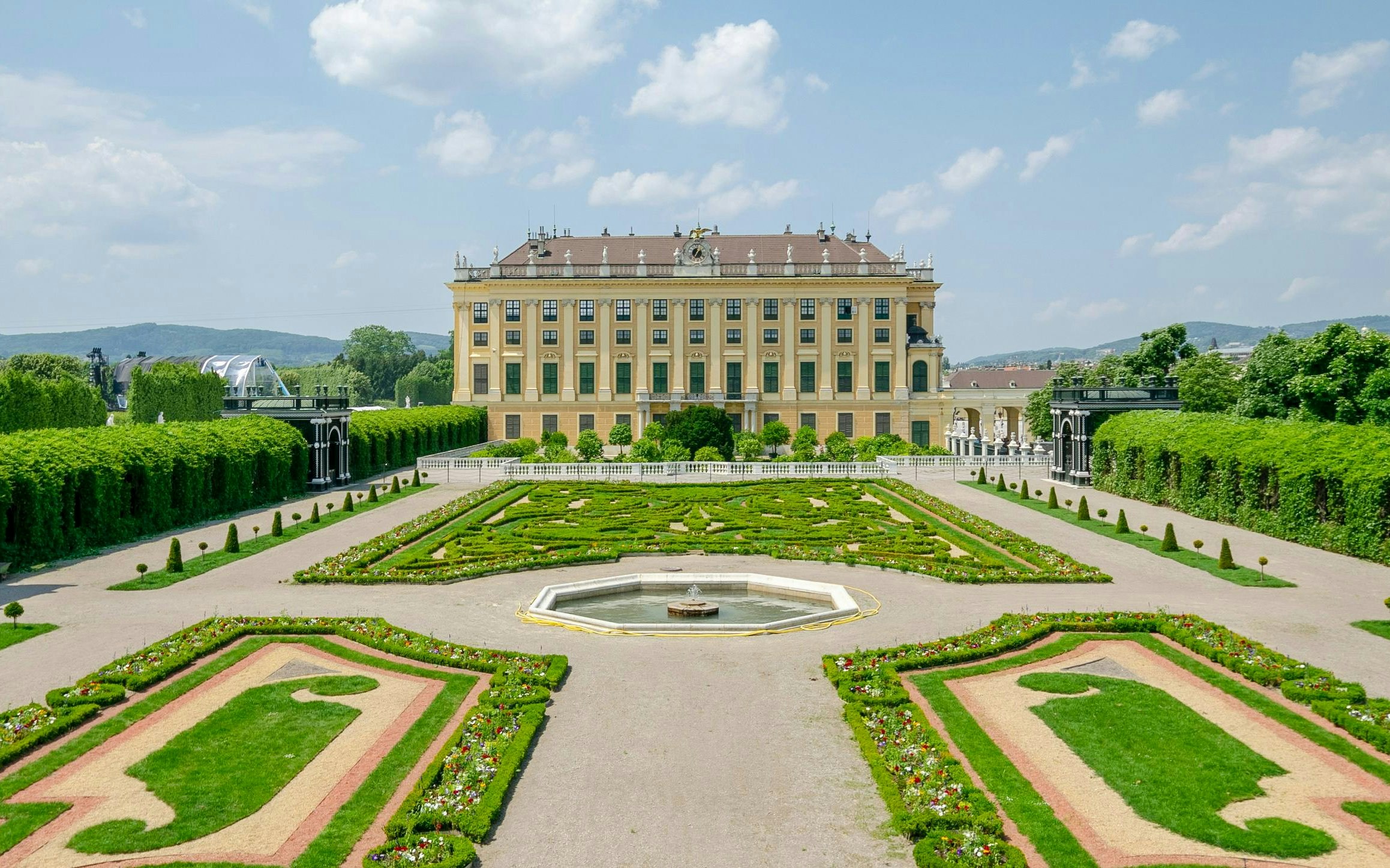 Privy Garden at Schönbrunn Palace with manicured hedges and central fountain, Vienna.