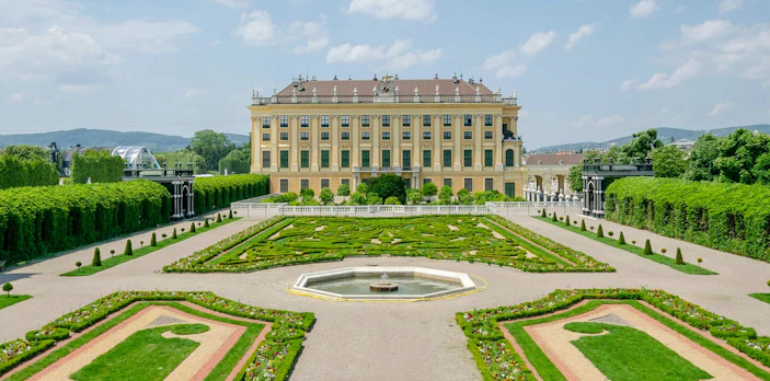 Privy Garden at Schönbrunn Palace with manicured hedges and central fountain, Vienna.