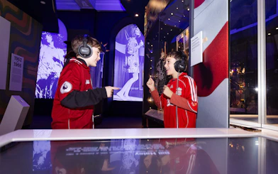 Children enjoying interactive exhibits at The British Music Experience in Liverpool.