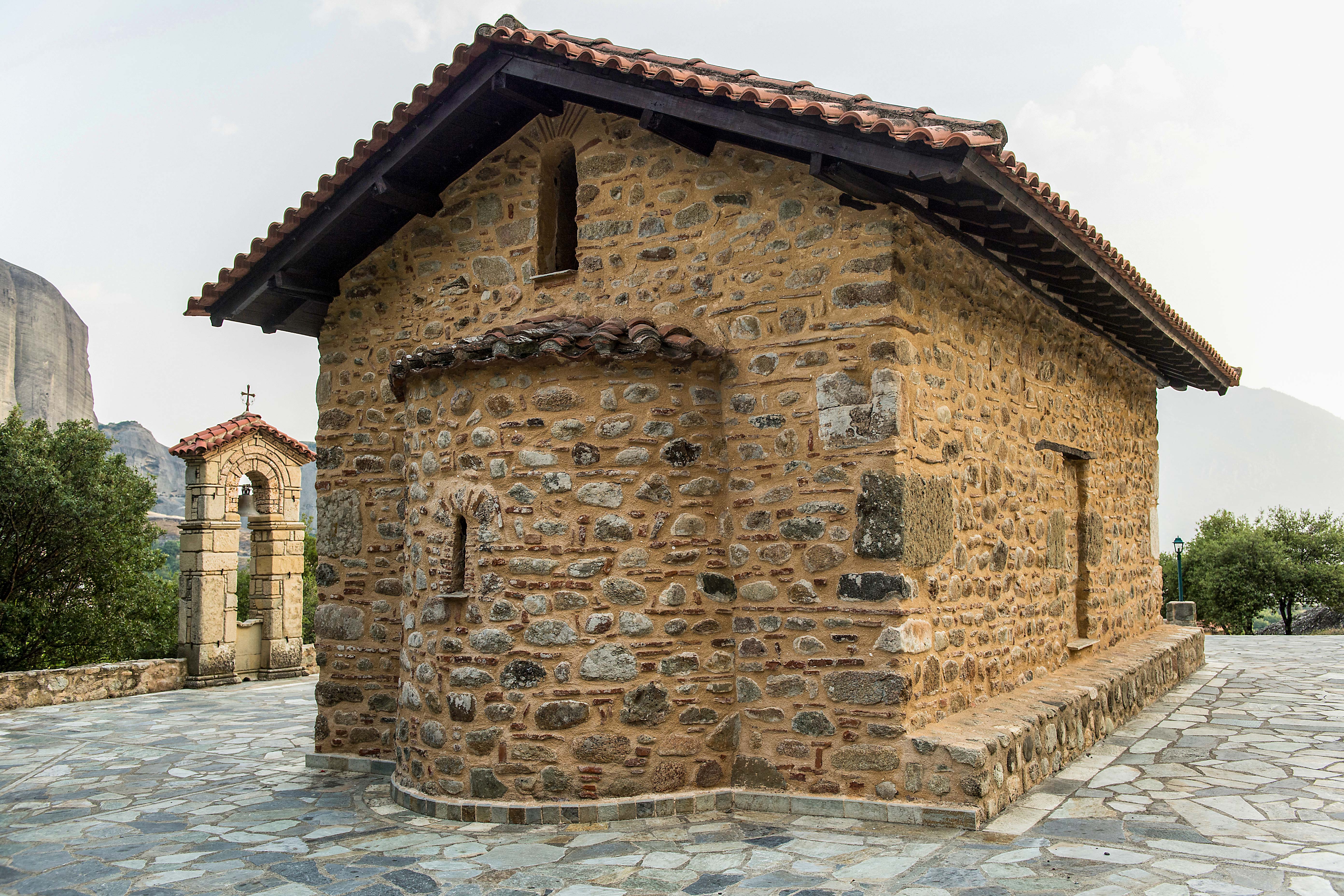 Chapel of Doupiani with stone walls and bell tower in Meteora, Greece.