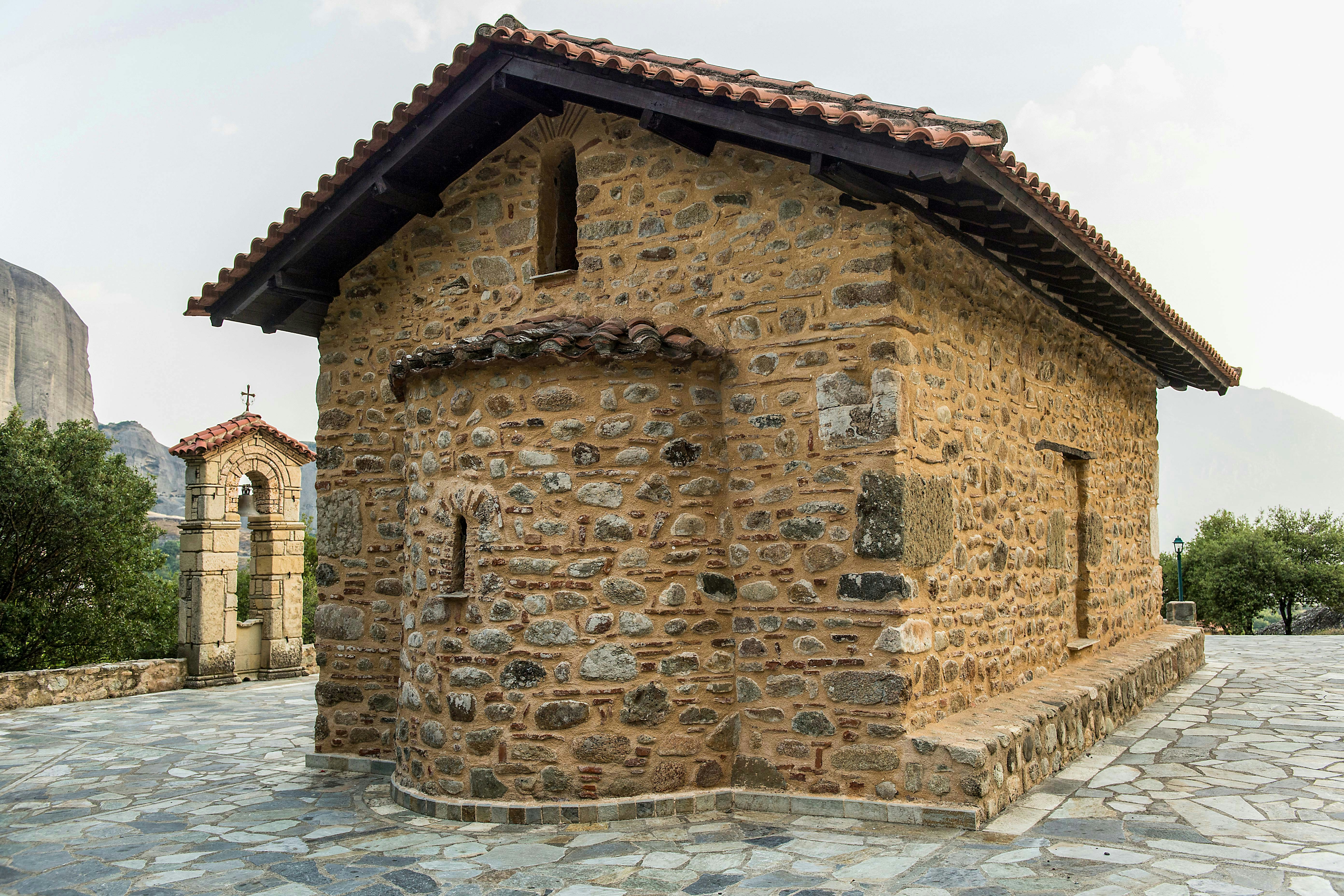 Chapel of Doupiani with stone walls and bell tower in Meteora, Greece.