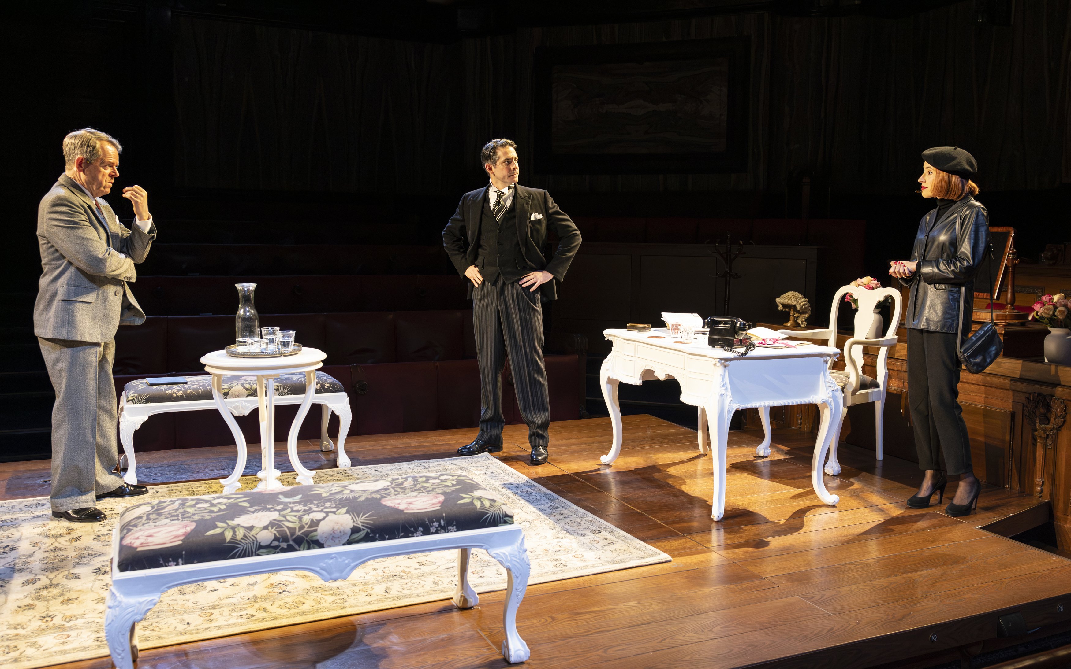 Courtroom scene from "Witness for the Prosecution" play with three actors on stage.