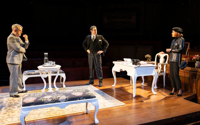 Courtroom scene from "Witness for the Prosecution" play with three actors on stage.