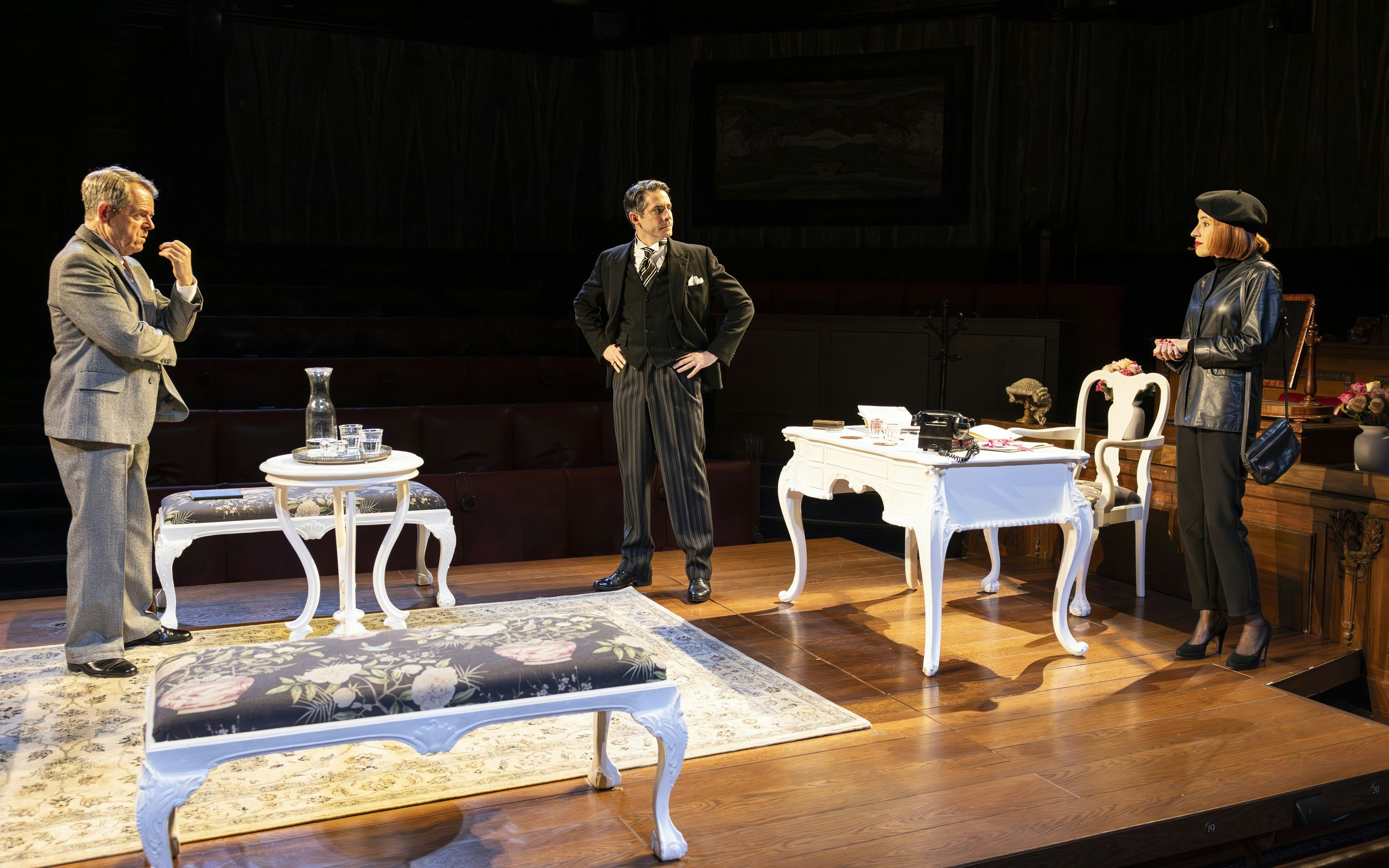 Courtroom scene from "Witness for the Prosecution" play with three actors on stage.