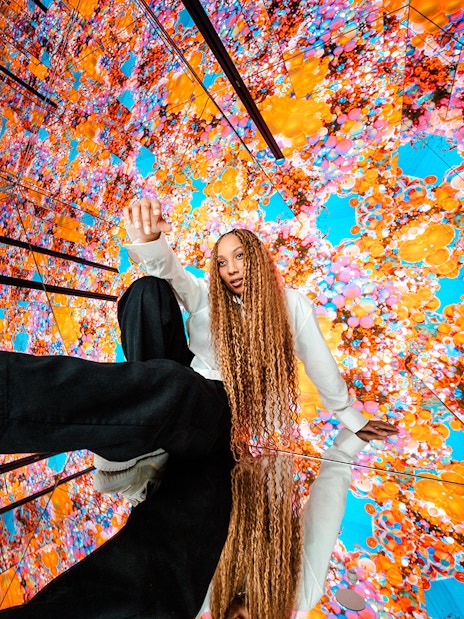 Visitors interacting with vibrant digital displays at House of Hype.