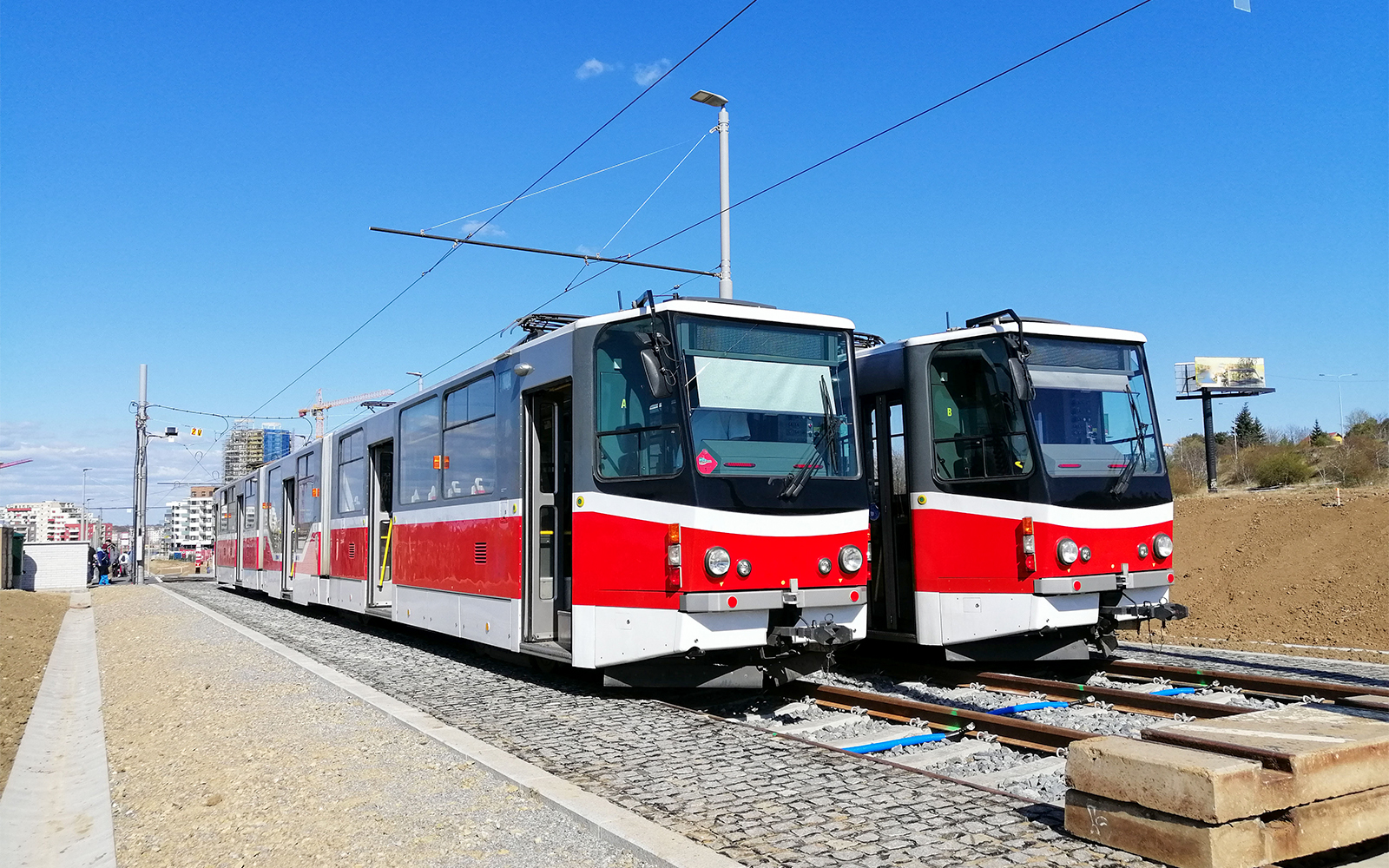 Red and white trams on tracks in Bratislava, Slovakia.