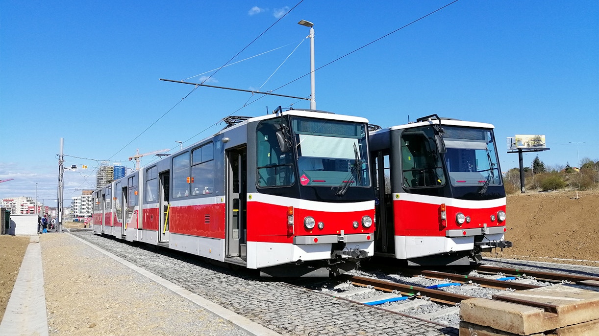 Red and white trams on tracks in Bratislava, Slovakia.