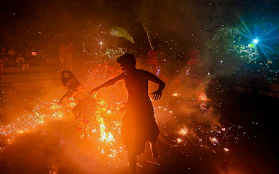 Performers in traditional Balinese attire enact a Ramayana scene with fire in Bali, Indonesia.