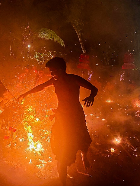 Performers in traditional Balinese attire enact a Ramayana scene with fire in Bali, Indonesia.