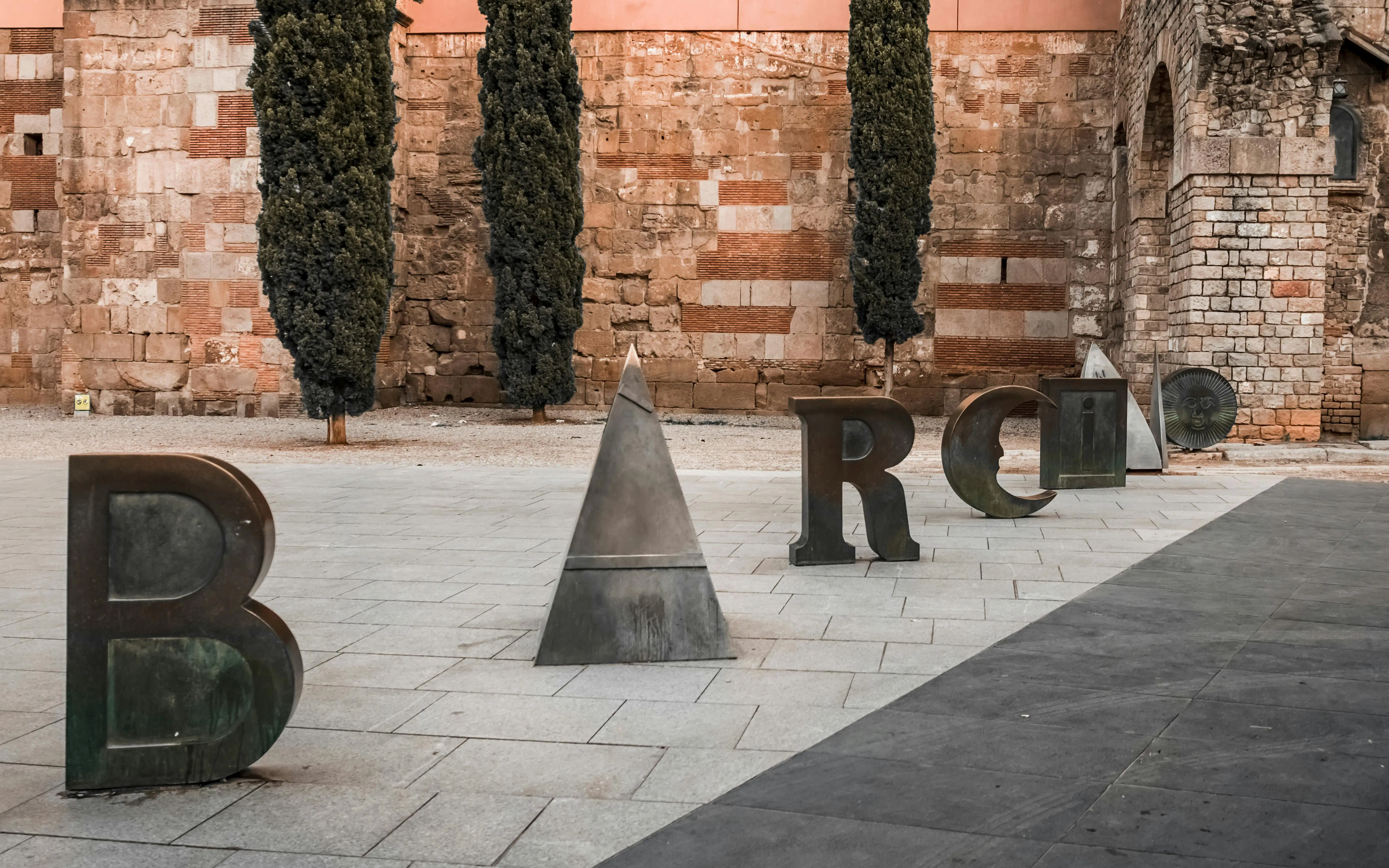 Sculpture spelling "Barcino" in Barcelona's Gothic Quarter.