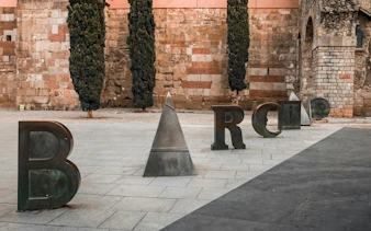 Sculpture spelling "Barcino" in Barcelona's Gothic Quarter.