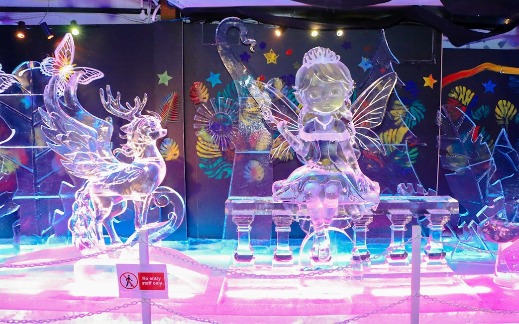 Ice sculptures of a fairy and reindeer at The Rainbow Frosty Playground, Singapore Snow City.
